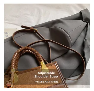 Detail of woven handle and adjustable leather strap on brown leopard print shoulder bag