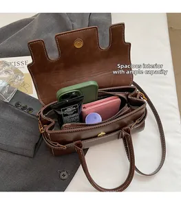 Interior view showing the large capacity of the vintage leather shoulder bag with white stitching