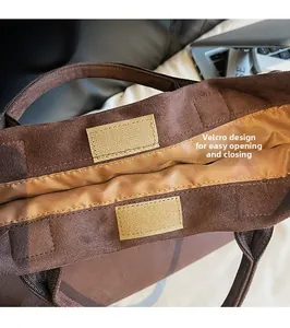 Detail of suede tote bag featuring a practical Velcro closure for quick access