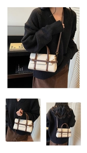 Detail view of vintage cream crossbody bag with brown leather trim and metal hardware buckle