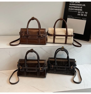 Detail view of four vintage crossbody bags in brown, beige, tea and grey finishes