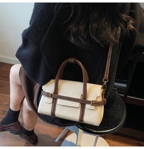 Dettagli della borsa a tracolla vintage crema con finiture marroni e fibbie dorate
