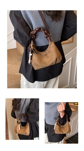 Close-up of coffee suede dumpling bag with pleated handle and beaded tassel detail