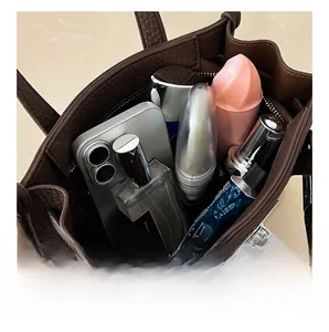 Top view of brown lychee grain leather handbag interior showing storage capacity for items