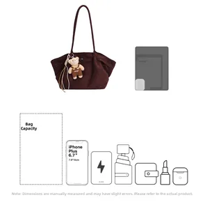 Detail view of large brown suede tote bag capacity with plush bear and daily essentials