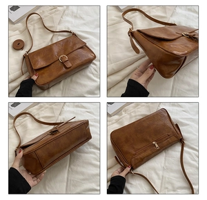 Close-up of brown vintage shoulder bag showing textured leather and back zipper pocket