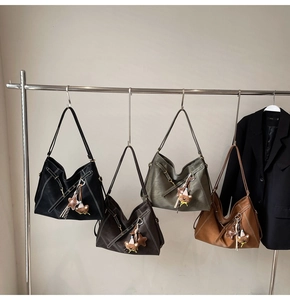 Detail of hobo tote bags in four colors with contrast stitching and cute charms