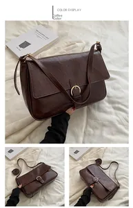 Detail of coffee brown PU leather bag featuring a gold ring buckle on beige fabric