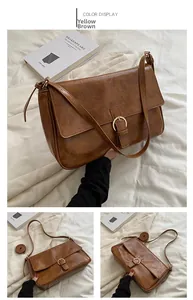 Detail view of yellow-brown retro crossbody bag with gold ring buckle and leather texture