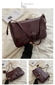 Detail view of wine red retro crossbody bag with glossy leather and gold buckle