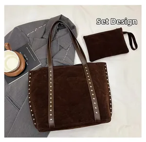 Detail view of large brown suede tote bag with silver rivets and matching pouch set