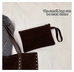 Detail showing a small brown suede pouch with zipper that can be used separately