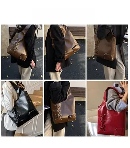 Detail view of large PU leather tote bag featuring side lace-up design and small outer pocket