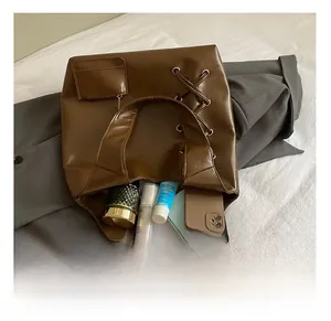 Detail view of large brown woven tote bag interior showing ample storage for daily items