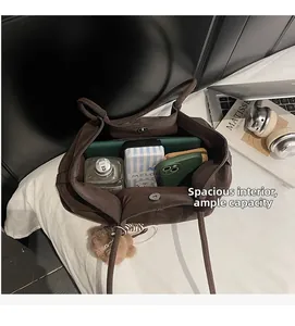 Spacious interior of dark brown suede tote bag showing large storage capacity