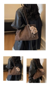 Detail view of large dark brown suede tote bag with cute plush puppy charm accessory