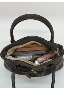Interior view of brown faux leather tote bag showing large capacity and zipper pocket