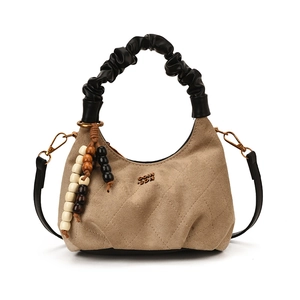 Quilted khaki dumpling bag with black pleated handle and colorful bead charm tassel