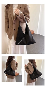 Detail view of black suede tote bag featuring diagonal silver metal rivet decorations