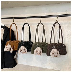 Four vintage suede shoulder bags in earthy tones with cute rabbit pendants and double pockets