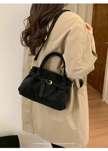 Minimalist retro black suede shoulder bag with gold hardware and belted lock detail