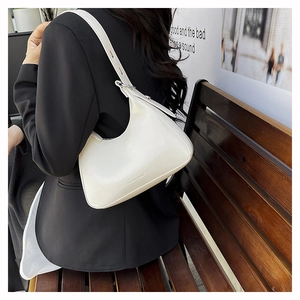 Close-up of white glossy hobo bag with adjustable strap and Fashion & Bags text