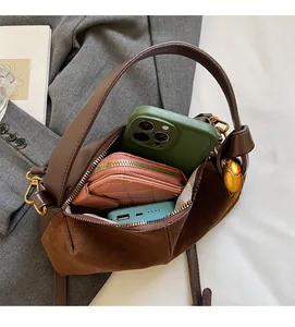 Interior view showing the spacious capacity of this brown suede crossbody handbag
