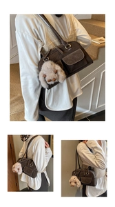 Macro detail of dark brown suede shoulder bag with utility pockets and rabbit charm