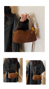Detail of brown faux suede Boston bag featuring a chunky gold metal chain strap