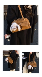 Detail view of a brown vintage tote bag with flap pockets and a plush rabbit charm