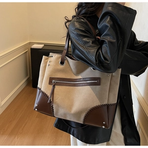 Dettaglio della grande borsa tote vintage in tela kaki e patchwork di pelle marrone