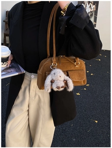 Brown vintage faux leather tote bag with front pockets and plush rabbit pendant detail