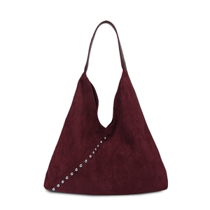 Detail of vintage burgundy suede hobo bag featuring silver rivet studs and a spacious design