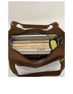Top view of spacious brown tote bag interior with striped lining and daily essentials