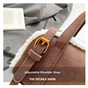 Detail of suede crossbody bag with plush faux fur trim and adjustable gold buckle strap