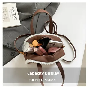 Internal view of the brown suede handbag showing spacious storage for makeup and phone
