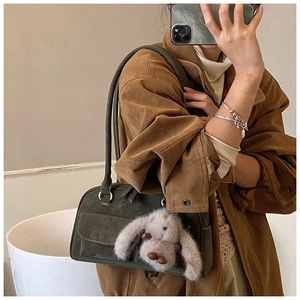 Vintage green suede shoulder bag with long handle and plush rabbit pendant detail