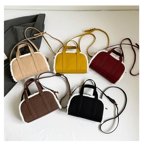 Flat lay of small faux shearling trim crossbody bags in five assorted autumn colors