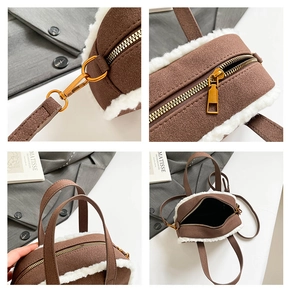 Detail view of brown suede bag showing lamb wool edges, metal hardware, and zipper