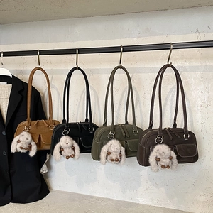 Vintage pillow handbags in four colors featuring dual front pockets and plush bunny charms