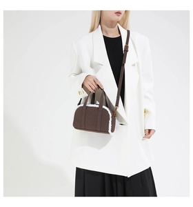 Brown bowling bag with plush faux fur trim and detachable gold hardware strap