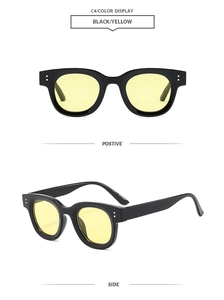 Détail de lunettes de soleil vintage avec monture noire et verres jaune océan