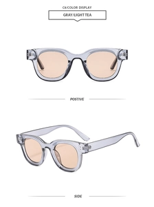 Détail de lunettes de soleil rondes vintage avec monture grise et verres thé clair