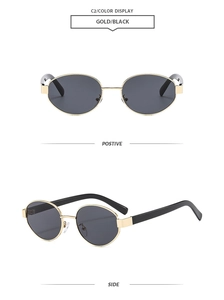 Detail view of oval retro sunglasses with gold metal frame and black lenses