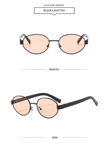 Detail of retro oval sunglasses with black metal frame and light tea tinted lenses