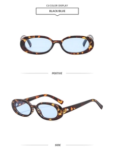 Detail view of retro oval sunglasses with tortoiseshell frames and light blue lenses