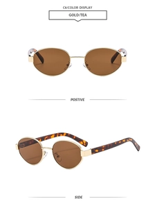 Detail view of oval retro sunglasses with gold metal frames and tortoiseshell temples