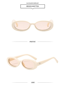 Detail of vintage beige oval sunglasses with light tea lenses and silver metal hinges