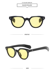 Detail of black thick frame sunglasses with yellow lenses and star-shaped metal accents