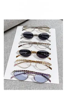 Detail of heart-shaped hollow metal frames with rhinestone accents on six colored sunglasses